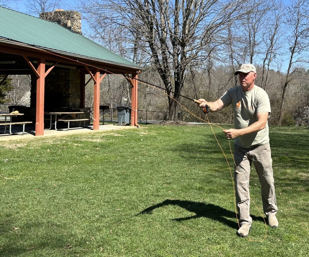 5 Feed and Shoot Mac Brown casting on the lawn